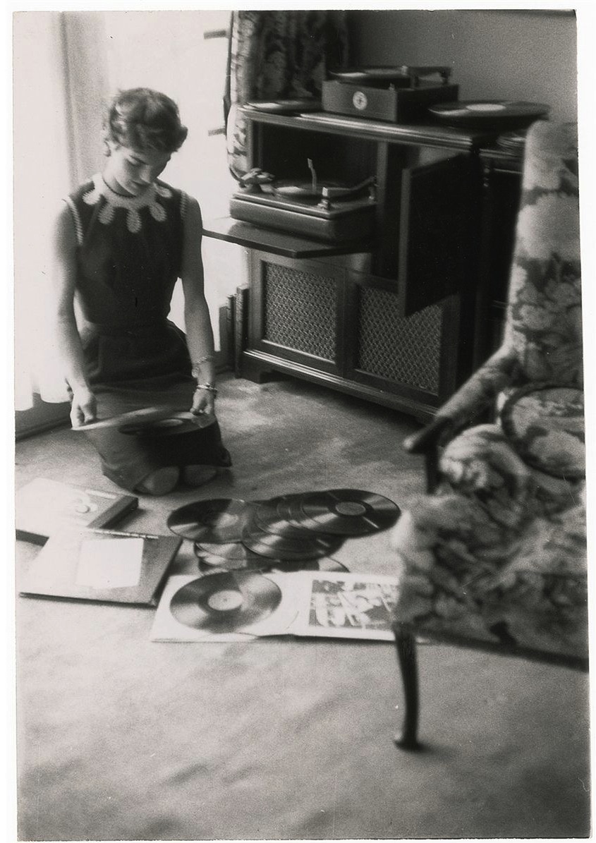 Before a dinner party, Jacqueline Kennedy sorted through record albums, choosing music to set the mood for her guests.