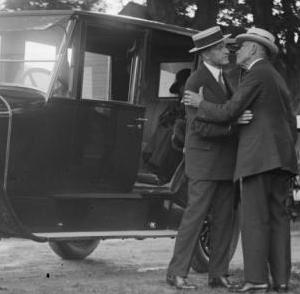 Defying conventional ideas of paternal displays of affection, John Coolidge (right) kisses his son the President.