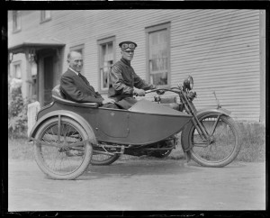First Father John Coolidge takes a ride with a Boston policeman. (Boston Public  Library)