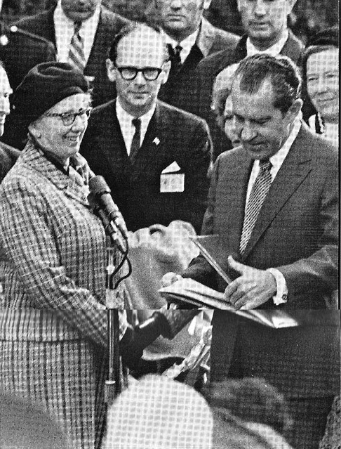 President Nixon looks over a Milhouse family record before visiting the Quaker cemetery in Ireland of his ancestors.