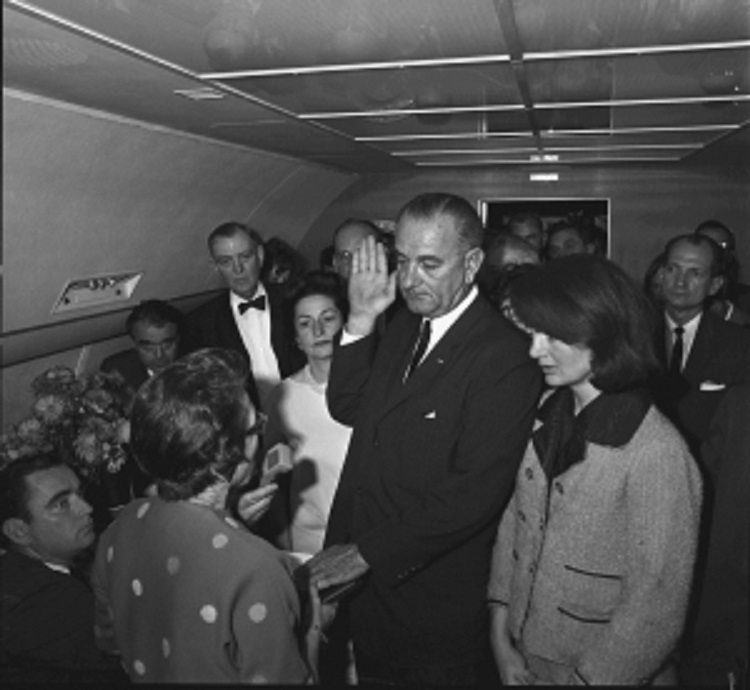 The famous image of Vice President Johnson taking the oath of office with his wife and Mrs. Kennedy just after President Kennedy's Dallas assassination. The famous image of Vice President Johnson taking the oath of office with his wife and Mrs. Kennedy just after President Kennedy's Dallas assassination.