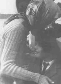 The new Mrs. Onassis kissing her son goodbye, following her wedding. (UPI)