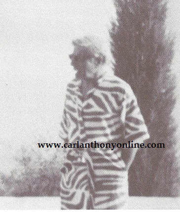 Ari Onassis with his cigar and zebra-striped robe on the taverna patio.