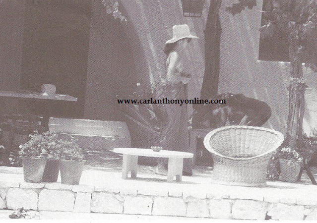 Jackie Onassis wraps a towel around her after some sunbathing.