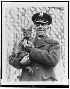 Tige, the second Coolidge White House cat, with an executive residence policeman.
