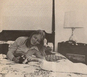 The 18 year old First Daughter Susan Ford in her White House bedroom with her Siamese cat.