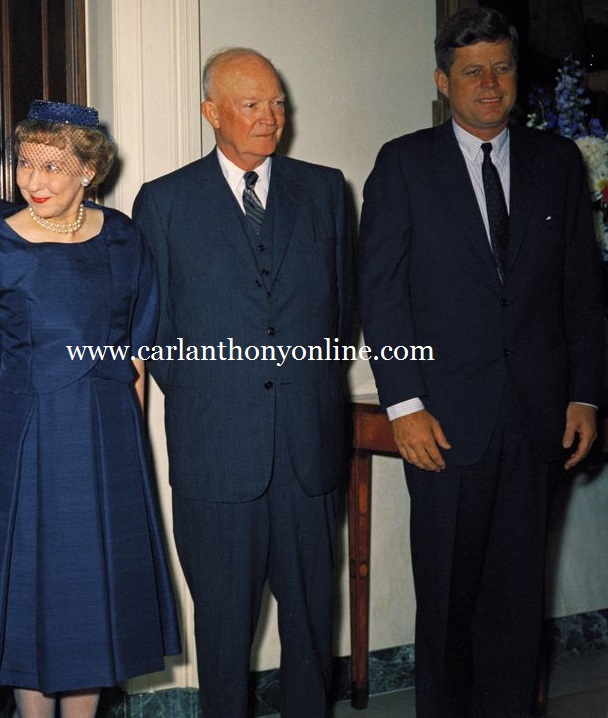 Eisenhower's wife smiles at Kennedy's wife, who is out of the picture's range. Eisenhower's wife smiles at Kennedy's wife, who is out of the picture's range.