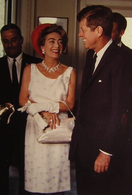 Joan Crawford laughing at a remark made by President Kennedy in the Oval Office, May 3, 1963.