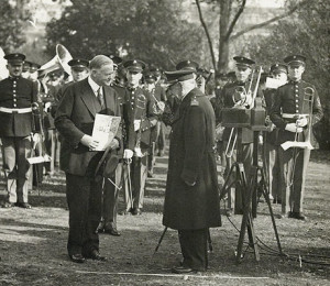 President Hoover accepts a copy of sheet music from the aged composer and Marine Band leader John Philip Sousa, written for George Washington's Birthday Bicentennial in 1932.