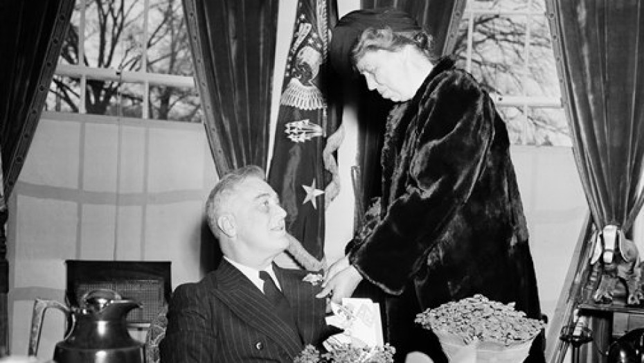 Eleanor Roosevelt in an affectionate gesture towards her husband President Franklin D. Roosevelt on St. Patrick's Day in the Oval Office, which was also their 36th wedding anniversary.