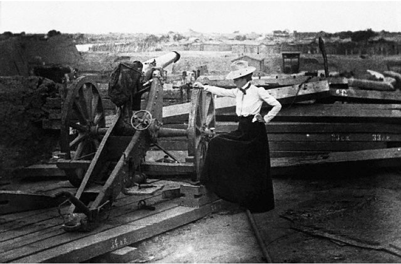Lou Hoover inspecting one of the cannons at a Chinese fort that shelled the community of Tientsin during the Boxer Rebellion, 1900.