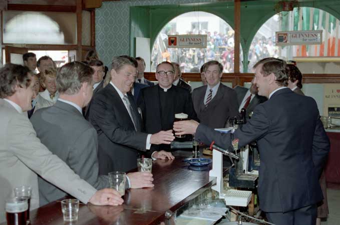 During his visit to the Irish town of his ancestors, President Reagan receiving a beer during a Visit to O'Farrell's Pub in Ballyporeen. June 3, 1984.