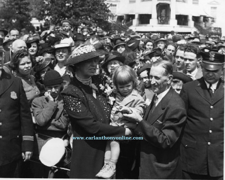 First Lady Eleanor Roosevelt at the 1939 Easter Egg Roll holding a lost child.