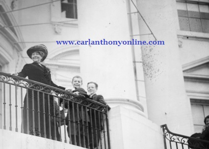 First Lady Ellen Wilson takes in the 1913 Easter Egg Roll from the South Balcony.