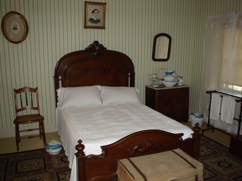 The bedroom of Andrew Johnson in his Tennessee home, his wife Eliza's portrait on the wall above; she had her own bedroom The bedroom of Andrew Johnson in his Tennessee home, his wife Eliza's portrait on the wall above; she had her own bedroom.