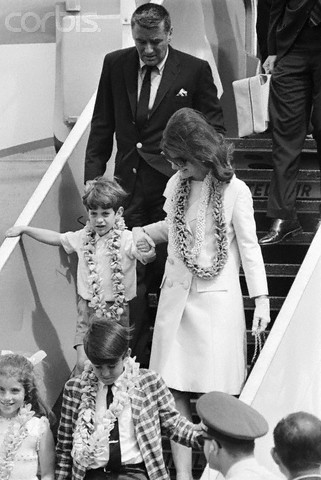 Jackie and John holding hands as they arrive in Hawaii.
