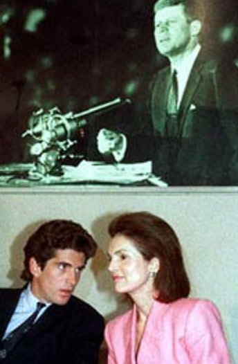 Mother and son confer beneath an image of their late husband and father at the first annual Profiles in Courage Award ceremony, 1989. Mother and son confer beneath an image of their late husband and father at the first annual Profiles in Courage Award ceremony, 1989.