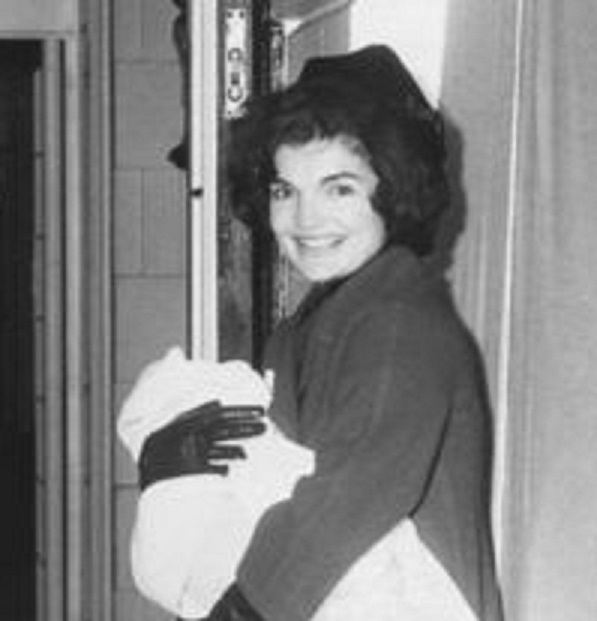 Jackie Kennedy carries her two and a half month old son John into the White House for the first time, February 1961. Jackie Kennedy carries her two and a half month old son John into the White House for the first time, February 1961.