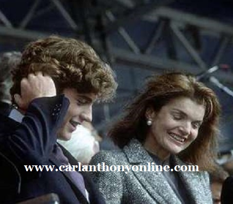 The late president's son and wife share a quip at the dedication of the JFK Library.