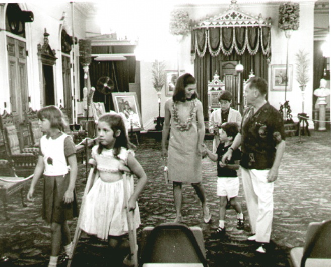 Jackie holds her son's hand as they walk through the Iolani Palace in Honululu, 1967. Jackie holds her son's hand as they walk through the Iolani Palace in Honululu, 1967.