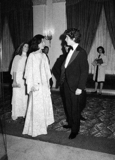 Bringing both children to a movie premier, Jackie has a word with her son. Bringing both children to a movie premier, Jackie has a word with her son.