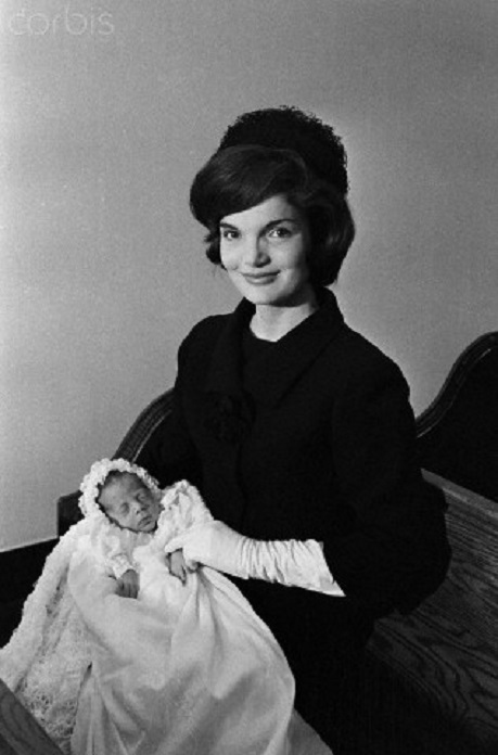 Jacqueline Kennedy poses with John at his baptism. Jacqueline Kennedy poses with John at his baptism.