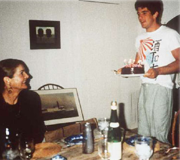 John carries out a birthday cake for his mother at her Martha's Vineyard home in the late 1980s, in an image snapped by cook Martha Scubin which also appeared in her book, Cooking for Madam. John carries out a birthday cake for his mother at her Martha's Vineyard home in the late 1980s, in an image snapped by cook Martha Scubin which also appeared in her book, Cooking for Madam.