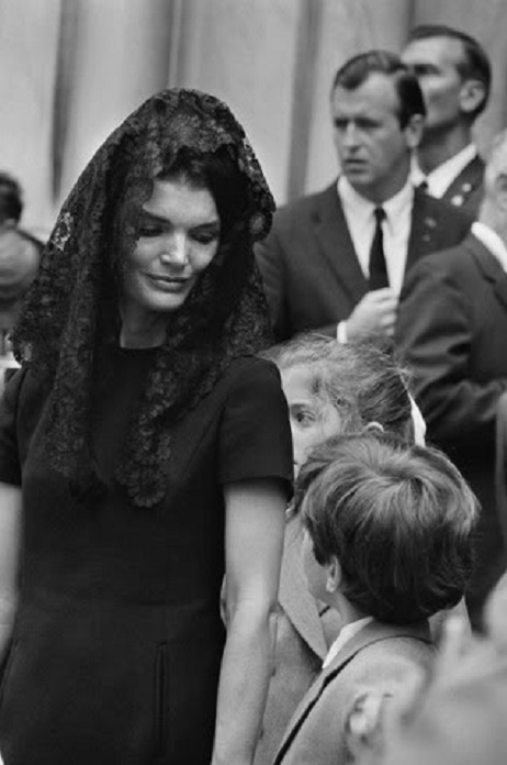 Jacqueline Kennedy holds her son's hand as they exit St. Patrick's Cathedral in New York, following the funeral of his uncle and her brother-in-law Senator Robert F. Kennedy. Jacqueline Kennedy holds her son's hand as they exit St. Patrick's Cathedral in New York, following the funeral of his uncle and her brother-in-law Senator Robert F. Kennedy.