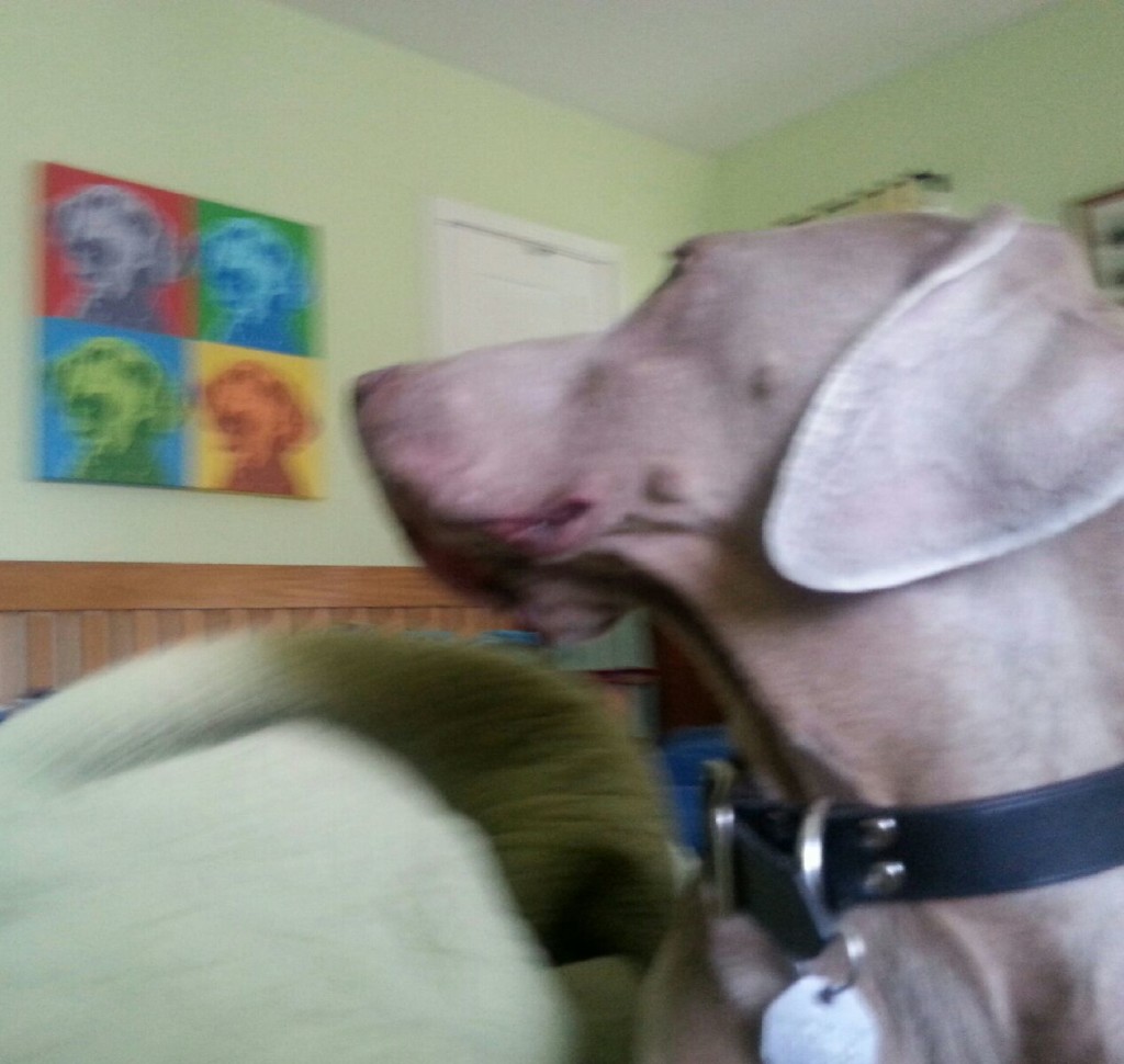 Hudson glances at a painting of Yeager.