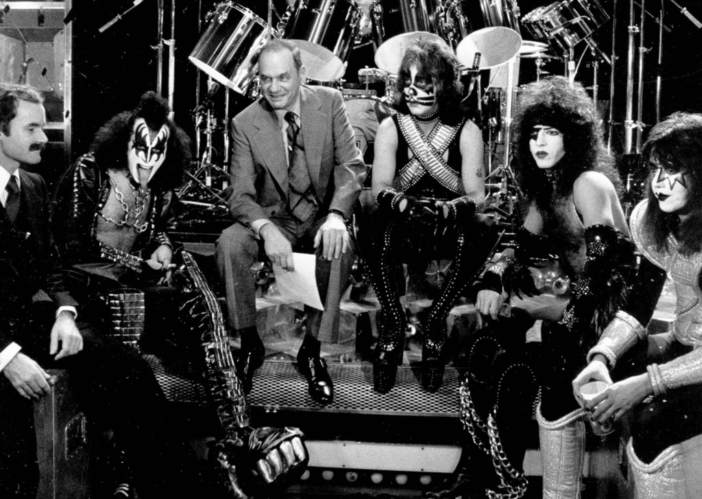 In Dcember 1977, NBC News correspondent Edwin Newman, third left interviews the rock group KISS, from second left, Gene Simmons, Peter Criss, Paul Stanley (AP)