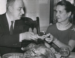 A very suspicious Mrs. Arthur Flemming hands over a plate of "approved" cranberry sauce to the man who caused the whole crisis.