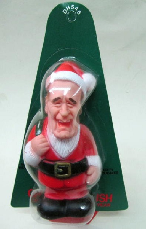 George H. Bush depicted as a peculiar plastic Santa Claus squeeze toy.