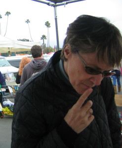 Ellen perusing the booths of the Rose Bowl flea market and bargaining down the prices.