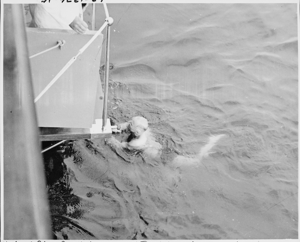 President Harry Truman takes a swim in the ocean, off the ship.