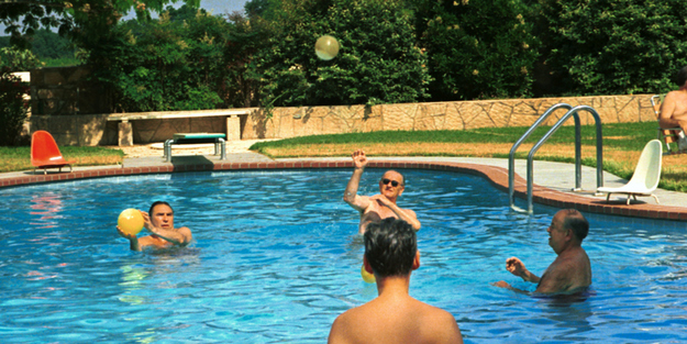 President Johnson engages some of his aides and advisers in a game of pool volleyball.
