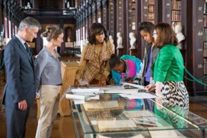 The First Lady and her daughters inspect an archive tracing the President's Irish ancestors during a Dublin visit in 2013.