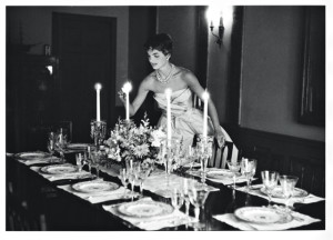 A popular image of Jacqueline Kennedy just months after her marriage, as she lights candles for the first dinner party she hosted with her husband, with guests including his U.S. Senate colleague John Sherman Cooper (Kentucky - R).
