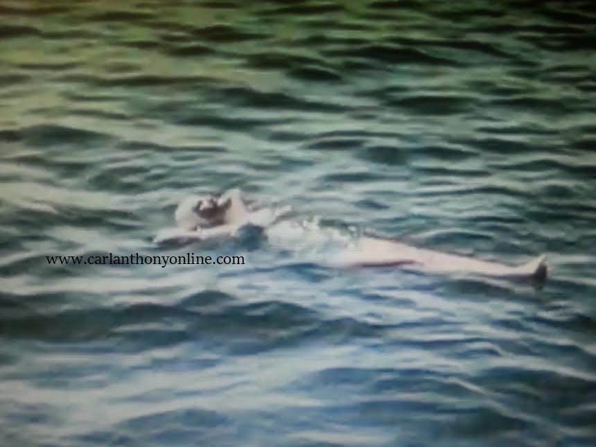 A screenshot from home movies shows Lady Bird Johnson floating on Lake Travis in Austin. She said she loved doing this and looking up at the sky.