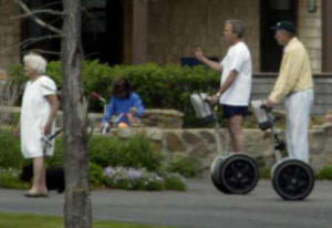 Both Bushs try Segway vehicles at their Maine estate in  June 2003.