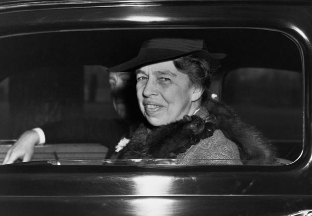 Eleanor Roosevelt smiles out at photographers from a White House limousine. (FDRL)