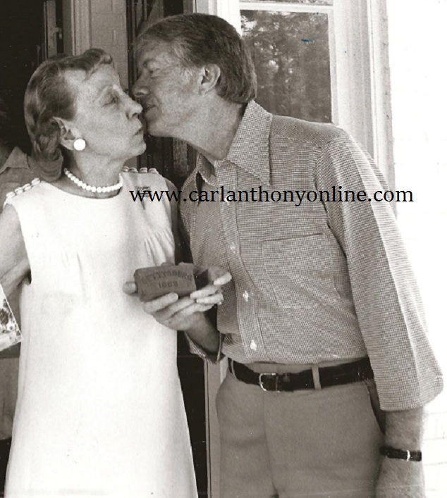 Jimmt Carter kisses former First Lady Mamie Eisenhower during a visit to her Gettysburg, Pennsylvania home in the summer of '78.