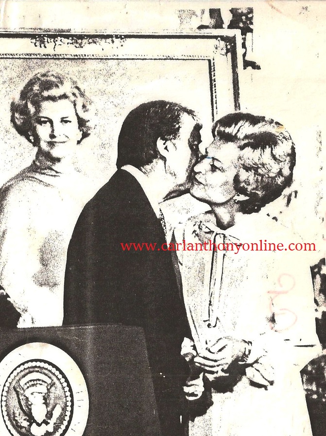 Jimmy Carter kissing Betty Ford at her White House portrait unveiling ceremony in 1978.
