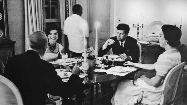 John and Jacqueline Kennedy entertaining Senator John Sherman Cooper and his wife Laraine at dinner in their Georgetown home.