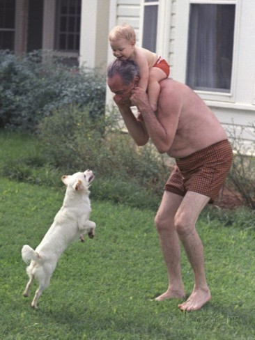 LBJ after a swim with his dog Yuki and his grandson Lyn on his shoulders, June 1, 1968.