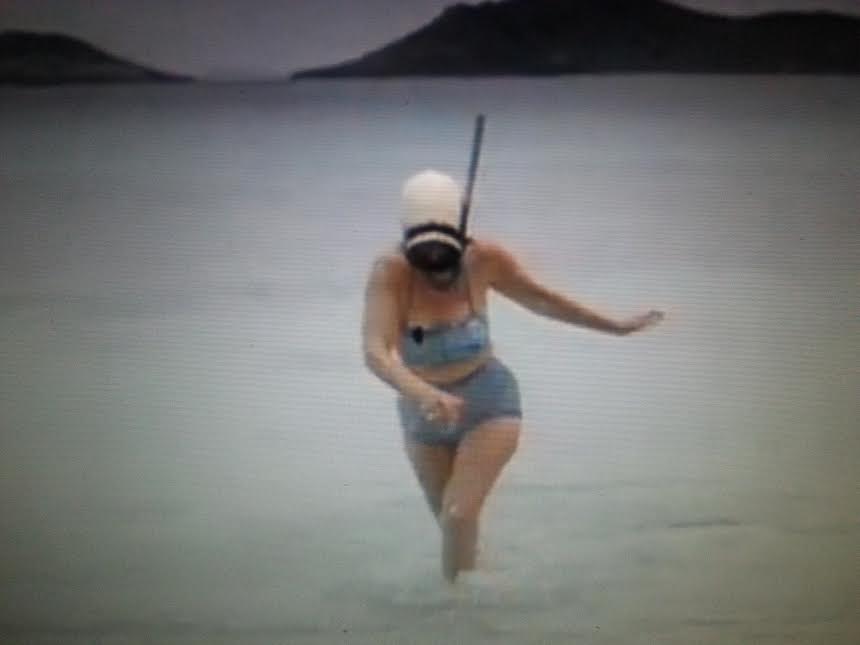 Who is the mystery First Lady emerging from a snorkeling session in her bikini?