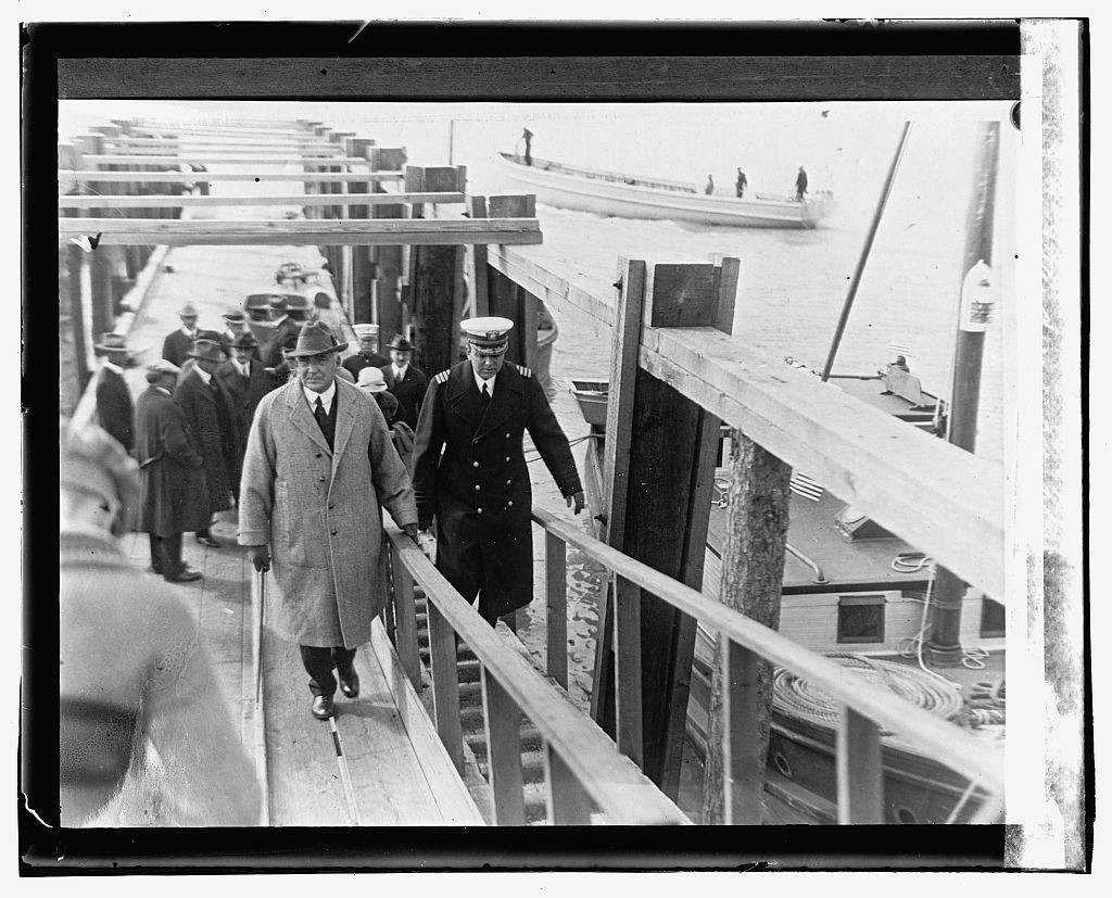 President Harding walks a gangway to resume the sea voyage through Alaska.