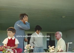 President Kennedy gestures to communicate with his father.