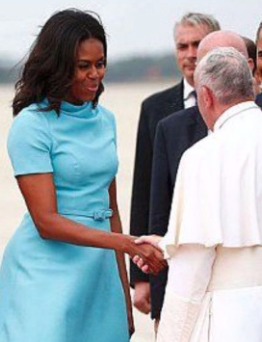First Lady Michelle Obama shakes hands with the Pope upon his arrival in Washington, September 24, 2015.