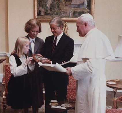 The Carters and the Pope exchange gifts during his visit with them in the White House family quarters.