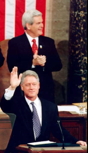 House Speaker Gingrich behind his nemesis, President Clinton.